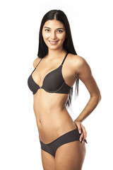 Fototapeta premium Portrait of a cheerful young woman in lingerie