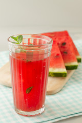 Glass of watermelon smoothie isolated on white.