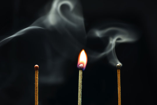 Burning match on a black background