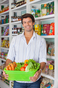 Man With Vegetable Basket In Supermarket