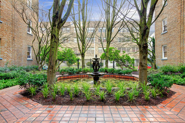 City apartment building main front yard with spring landscape.