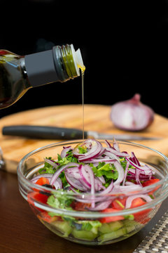 Fresh salad with onions and olive oil dressing.