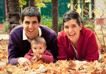 Happy family at the park in autumn