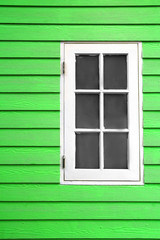 white wood window and green plank wall