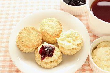Home-baked scones with clotted cream, blackcurrant jam and tea