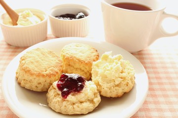 Home-baked scones with clotted cream, blackcurrant jam and tea