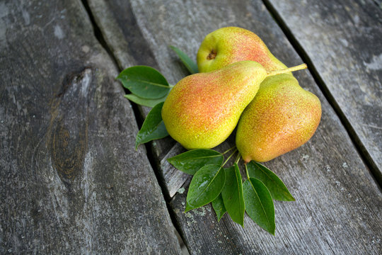 fresh pears on wooden surface