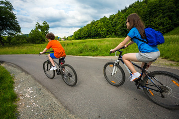Naklejka premium Healthy lifestyle - teenage girl and boy biking