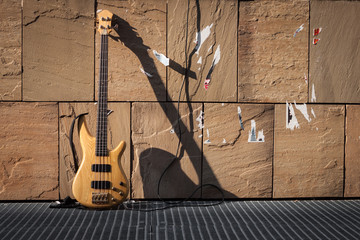 Bass guitar against a wall