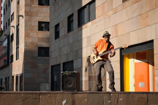 Young musician playing bass guitar