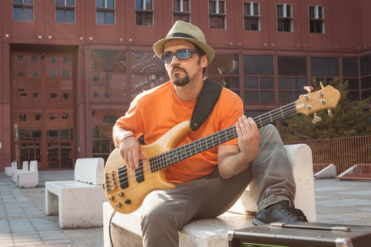 Young musician playing bass guitar