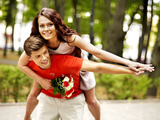 Couple with flower at park.