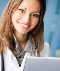 Cheerful female doctor with laptop