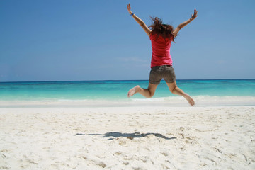 asia women jump on beach