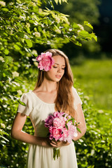 beautiful girl with bouquet of flowers in outdoor