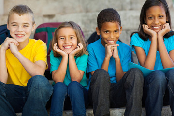 primary school children sitting outdoors