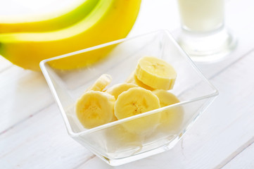 Fresh banana in the glass bowl, banana and milk
