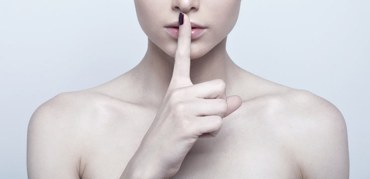 Woman With Finger On Lips