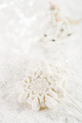 Fototapeta na wymiar marshmallow lolly snowflake on white festive backround