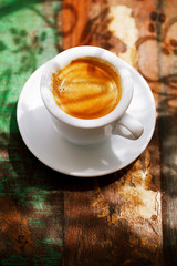 espresso coffee cup on rustic table with sun