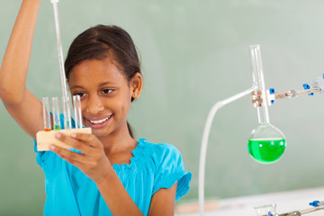 elementary student working with liquid in chemistry class