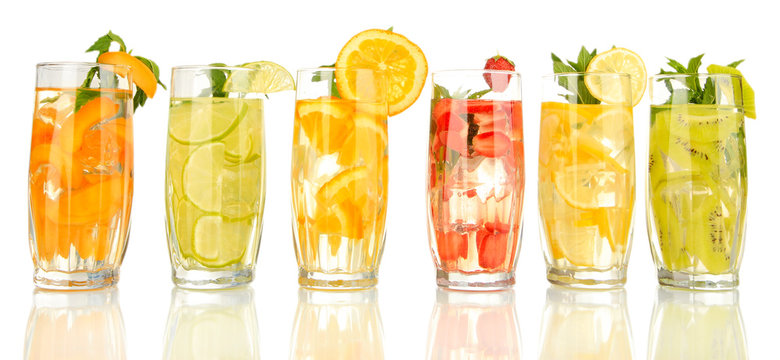 Fototapeta Glasses of fruit drinks with ice cubes isolated on white