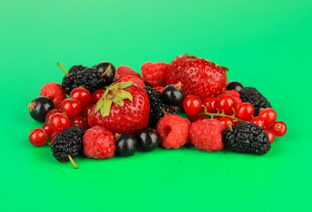 Ripe berries on green background