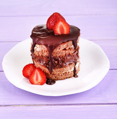 Chocolate cake with strawberry on wooden table close-up
