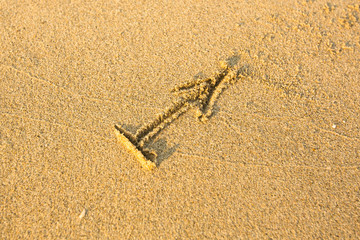 Zodiac sign Sagittarius, drawn on the facture beach sand.