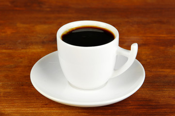 Cup of coffee on wooden table close-up