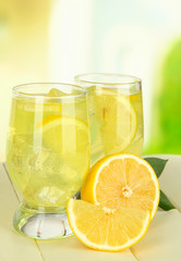 Delicious lemonade on table on light background