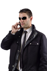 Man on a suit with jacket answering cellphone