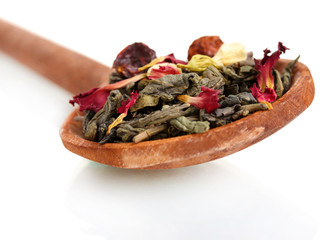 Green dry jasmin tea in woooden spoon isolated on white