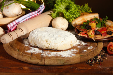 delicious pizza dough, spices and vegetables