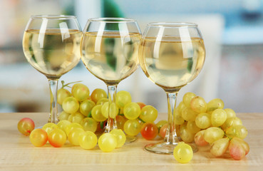 White wine in glass on room background