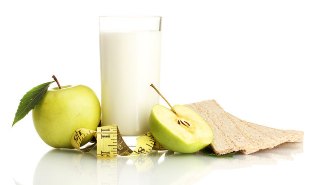 Glass of kefir, green apples, crispbreads and measuring tape