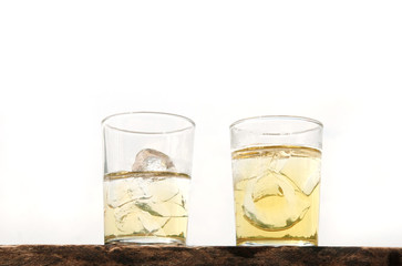 two lager beer with ice glass on wood isolated
