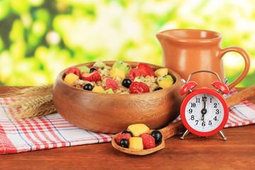 Oatmeal with fruits on table on bright background