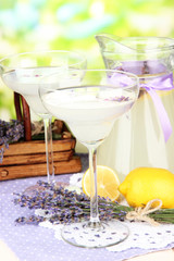 Lavender lemonade in glass jug and cocktail glasses,