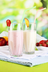 Delicious milk shakes with strawberries and peach
