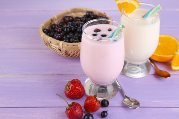 Delicious milk shakes with orange and blackberry