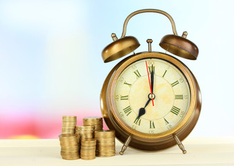 Alarm clock on table on light background