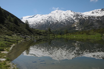 Fototapeta na wymiar Stockhorn reflected in Leisee lake in Swiss Alps