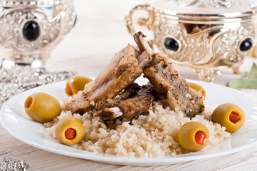 Moroccan tagine with lamb ribs, couscous and olives - 54615487