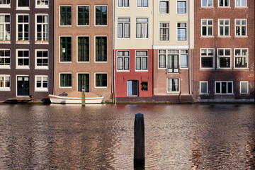 Fototapeta na wymiar Houses on Water in Amsterdam Netherland