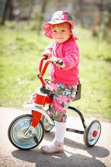 little girl on tricycle