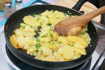 black pan with potato cooking