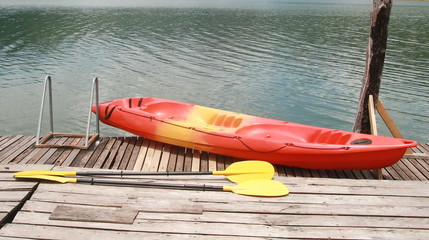 Red kayak on wood floor