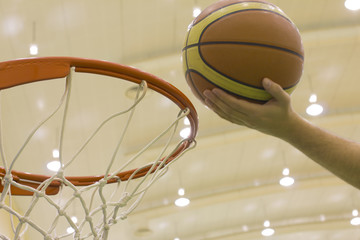 scoring basket in basketball court