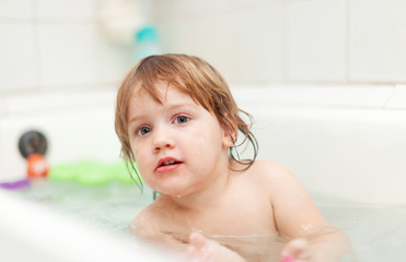   child bathes in bathtub